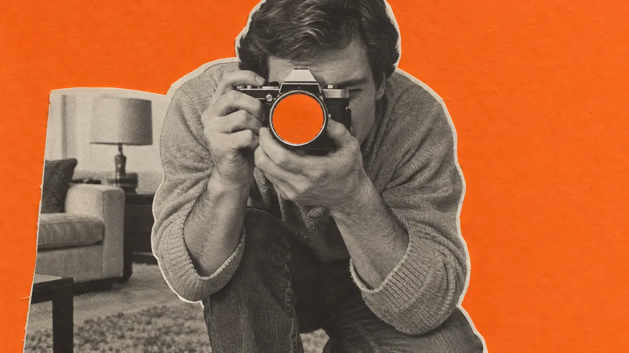 Collage aus einem Schwarz-Weiß-Foto eines hockenden Fotografen im Wohnzimmer, das Objektiv aus orangefarbenem Papier
