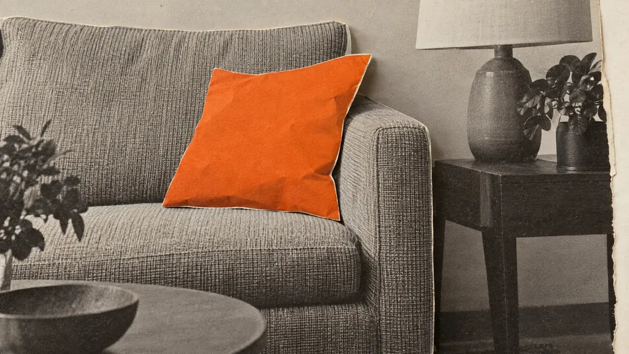 Collage of a black-and-white photo of a stylish sofa and side table, the throw cushion in orange paper