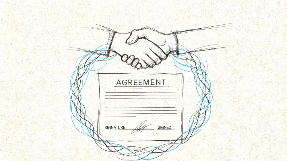 Handshake over a signed agreement document symbolizing a successful house price negotiation.